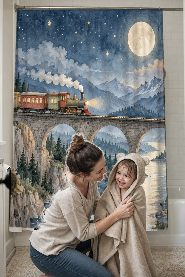 Mom drying her toddler in a hooded towel in front of the Moonlit Train shower curtain