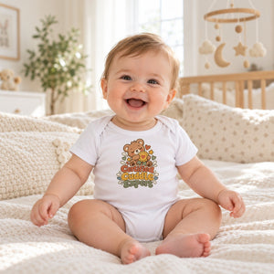 Baby wearing the Certified Cuddle Expert baby bodysuit