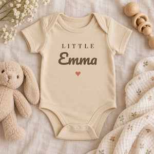 Styled flat lay of the Little Name baby bodysuit