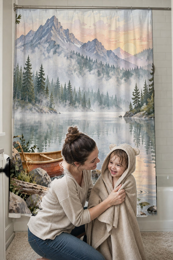 Mom drying her toddler in a hooded towel in front of the Canoe Lake Camping shower curtain