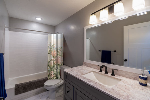 Pastel Tulip Field shower curtain pulled open in a gray kids bathroom