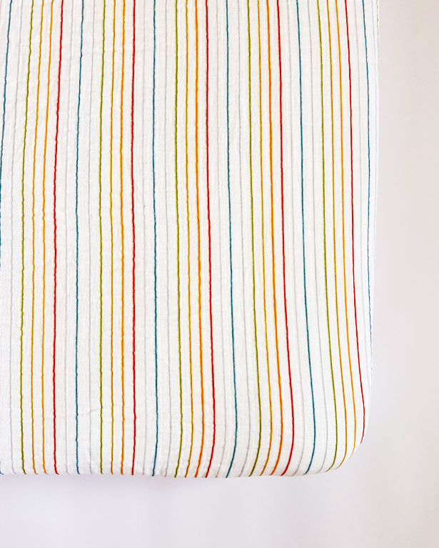 Rainbow Stripe Crib Sheet for a colorful and cozy nursery bedding solution.
