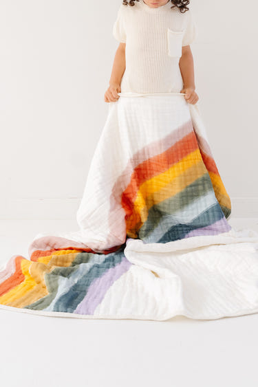 Colorful Rainbow Connection Quilt for babies, perfect for cozying up and adding charm to nursery decor.