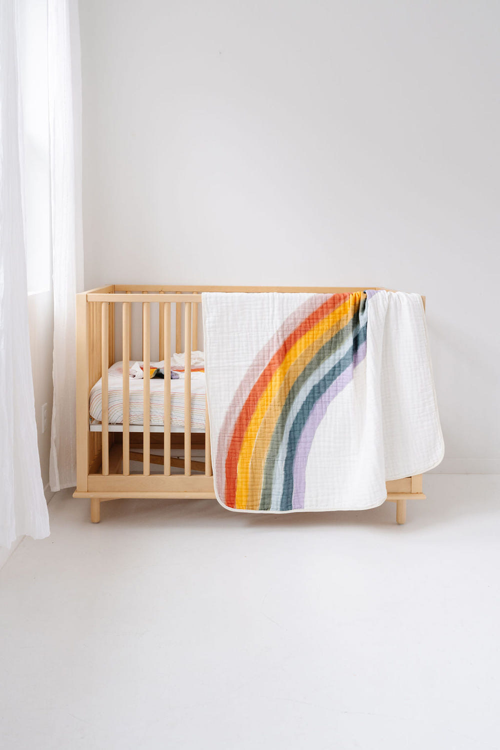 Colorful Rainbow Connection Quilt for babies, perfect for cozying up and adding charm to nursery decor.