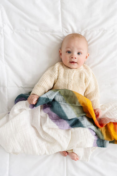 Rainbow Connection Swaddle for babies, featuring a colorful design for comfort and style. Perfect for cozy sleep.