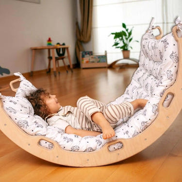 Montessori climbing arch rocker with origami pillow for baby play, promoting physical development and creativity.