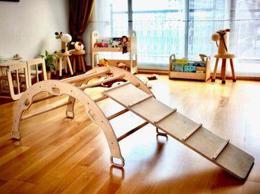 Wooden climbing arch with ladder ramp and star pillow set for babies, perfect for active play and development.