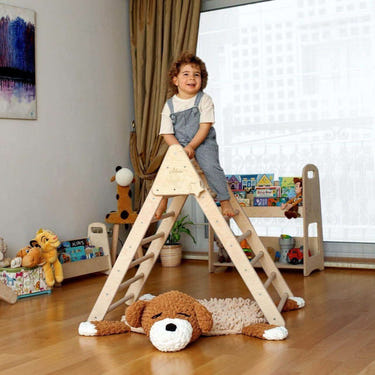 Foldable Montessori climbing triangle with ramp for babies, promoting active play and development.