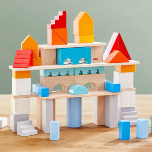 Colored wooden building blocks set of 85 pieces, perfect for creative play and architectural exploration for babies.