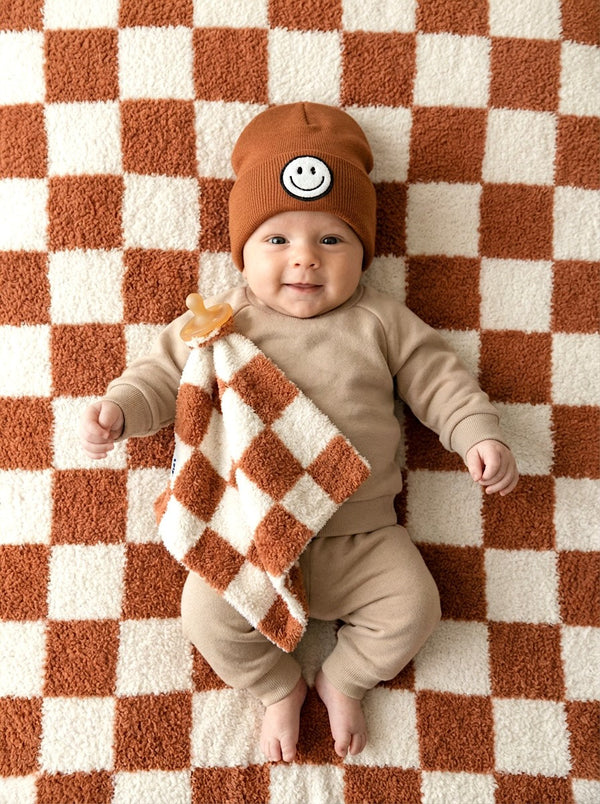 Checkered plush lovey in copper color, perfect for comforting babies and toddlers.