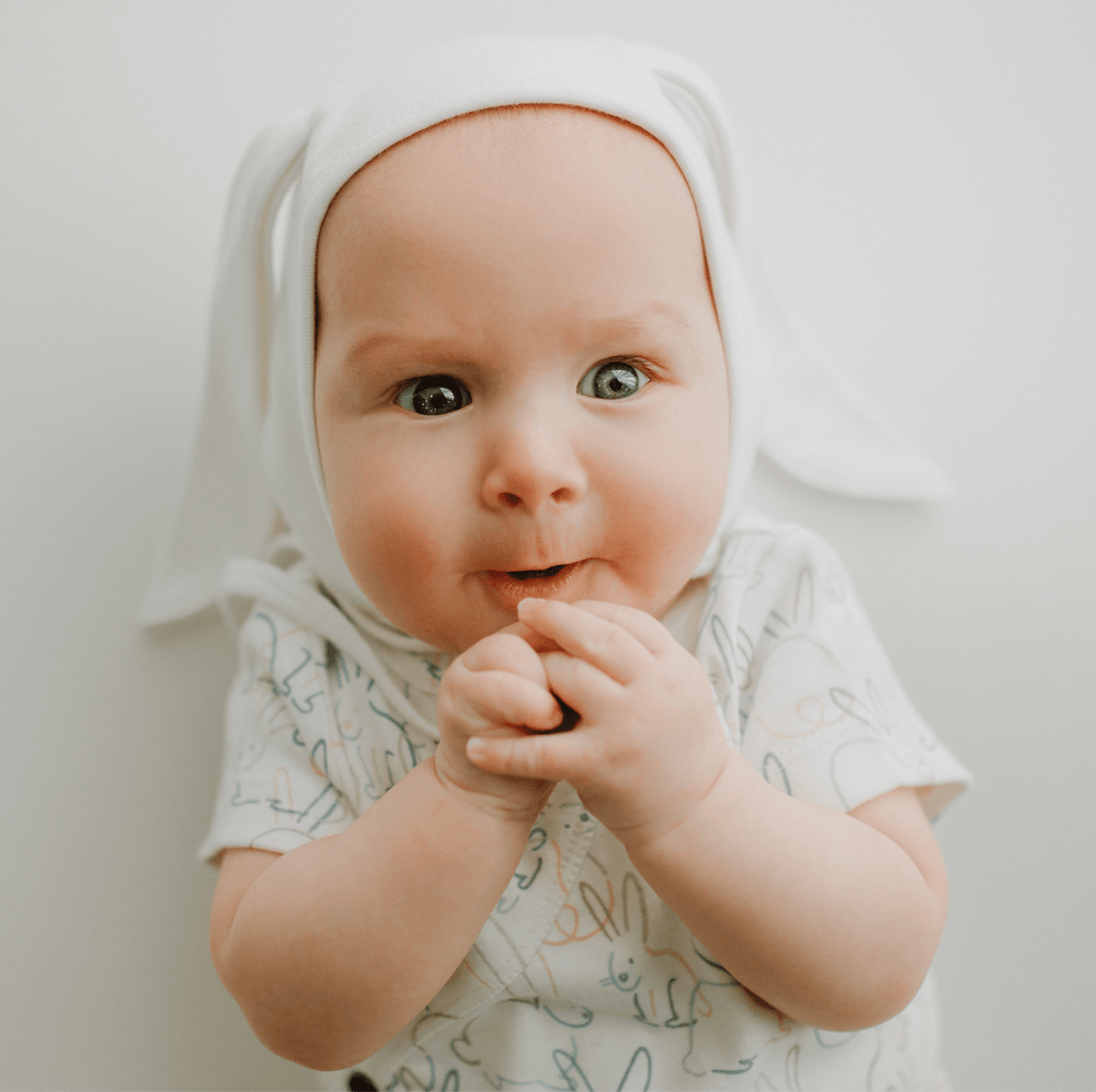Short sleeve baby bodysuit featuring adorable bunnies, perfect for comfort and style.