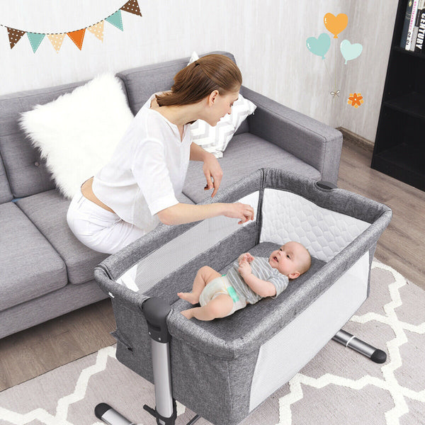 Portable baby bed side sleeper bassinet crib with carrying bag for travel convenience and comfort.