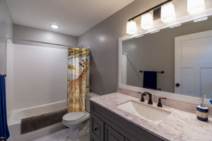 Baby Giraffe Safari shower curtain pulled open in a gray kids bathroom