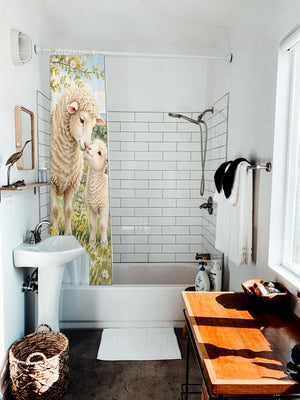 Lamb Meadow Farm shower curtain hanging on the rod over a white bathtub