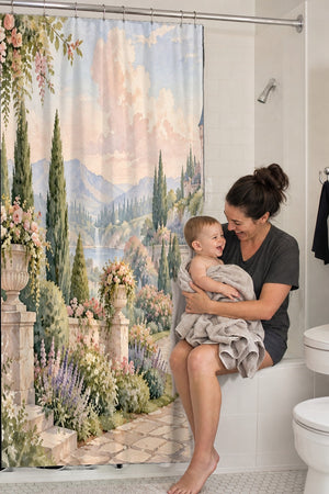 Mom holding her baby on the tub edge next to the Castle Garden Fairy Tale shower curtain