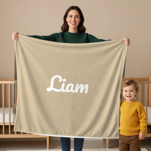 Classic Name toddler minky blanket in oatmeal, held by a mom