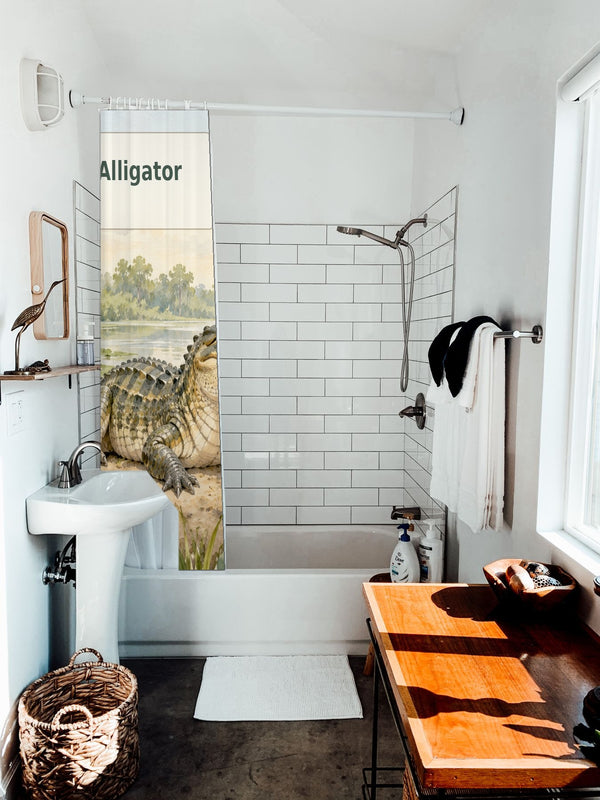 A is for Alligator Alphabet shower curtain hanging on the rod over a white bathtub