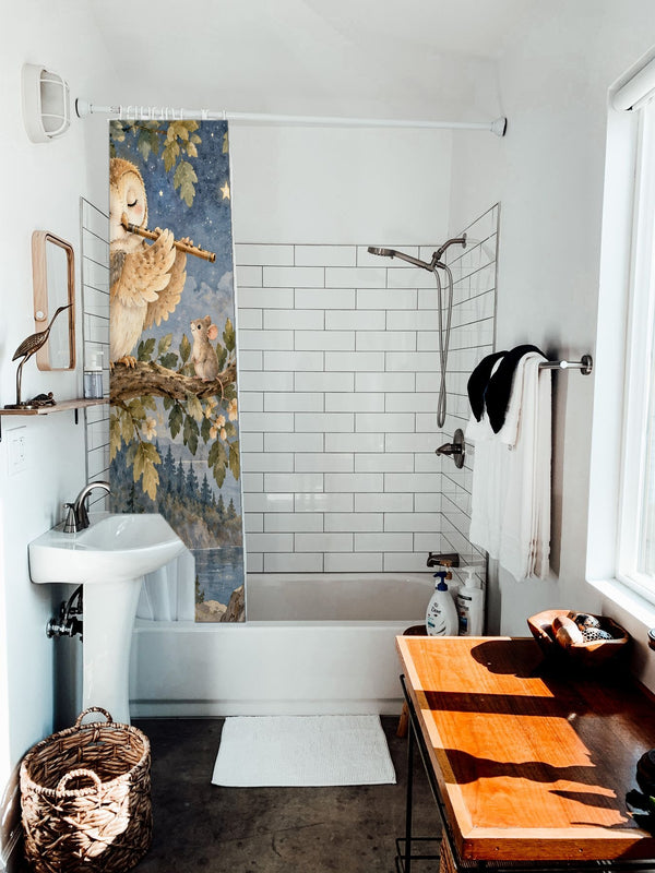 Owl Flute shower curtain hanging on the rod over a white bathtub