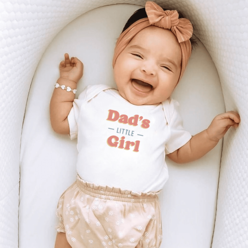 "Graphic bodysuit for baby girls, 'Dad's Little Girl', short sleeve design, perfect for stylish infant outfits."