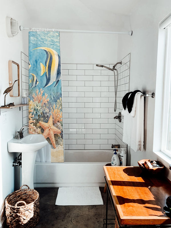 Coral Reef Ocean shower curtain hanging on the rod over a white bathtub