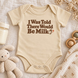 Styled flat lay of the I Was Told There Would Be Milk baby bodysuit