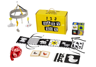 Montessori Educational Box for babies 0-2 months, promoting sleep and development in a cozy bedding setting.