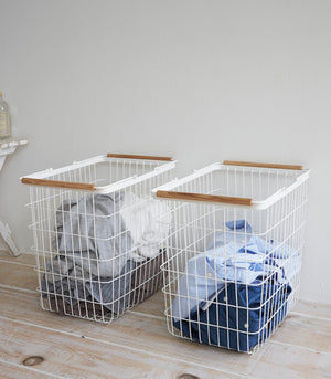 Wire basket in two sizes, featuring steel and wood design, perfect for laundry organization. Angle 8 view.