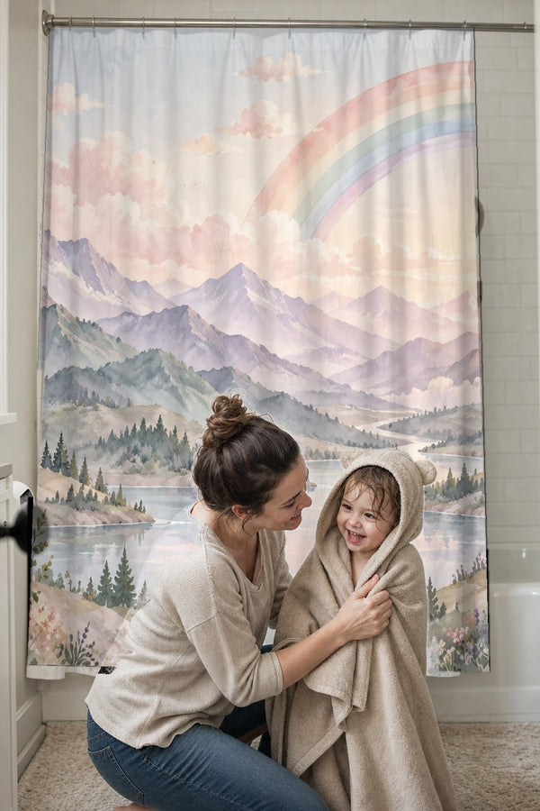 Mom drying her toddler in a hooded towel in front of the Lavender Peaks Rainbow shower curtain