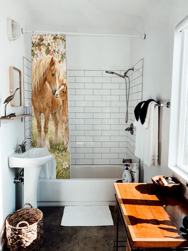 Pony Orchard Farm shower curtain hanging on the rod over a white bathtub