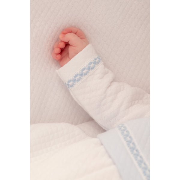 Boys white and blue quilted cotton romper, angle view, perfect for stylish baby outfits.