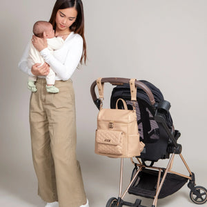 Pastel pink Petit Diaper Bag at angle 13, stylish and functional for modern parents.