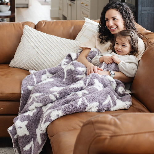 Double-layer Bamboni® toddler blankets in soft colors, perfect for swaddling and keeping your baby cozy.