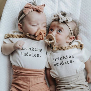 "Graphic short sleeve bodysuit for babies featuring 'drinking buddies' design, perfect for playful outfits."