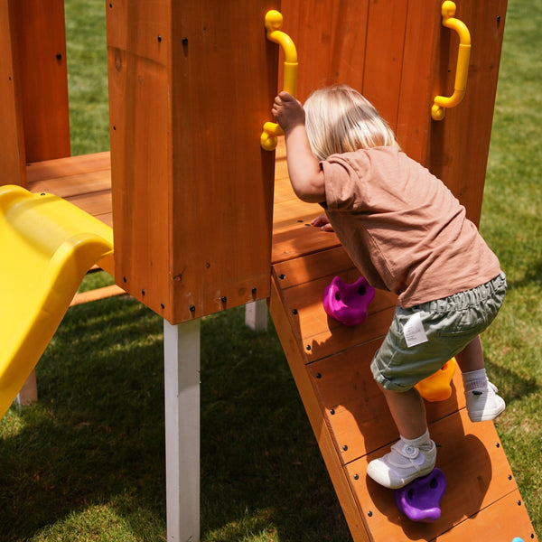 Compact wooden toddler swing set for outdoor play, perfect for babies and kids in a forest setting.