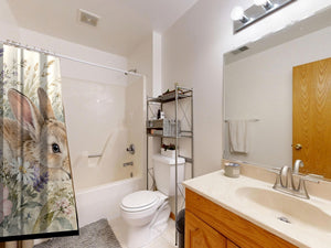 Lavender Bunny shower curtain on a tub shower combo in an American family bathroom