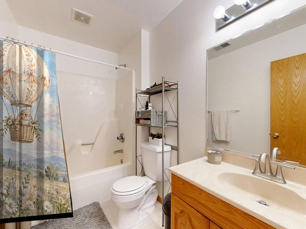 Meadow Hot Air Balloons shower curtain on a tub shower combo in an American family bathroom