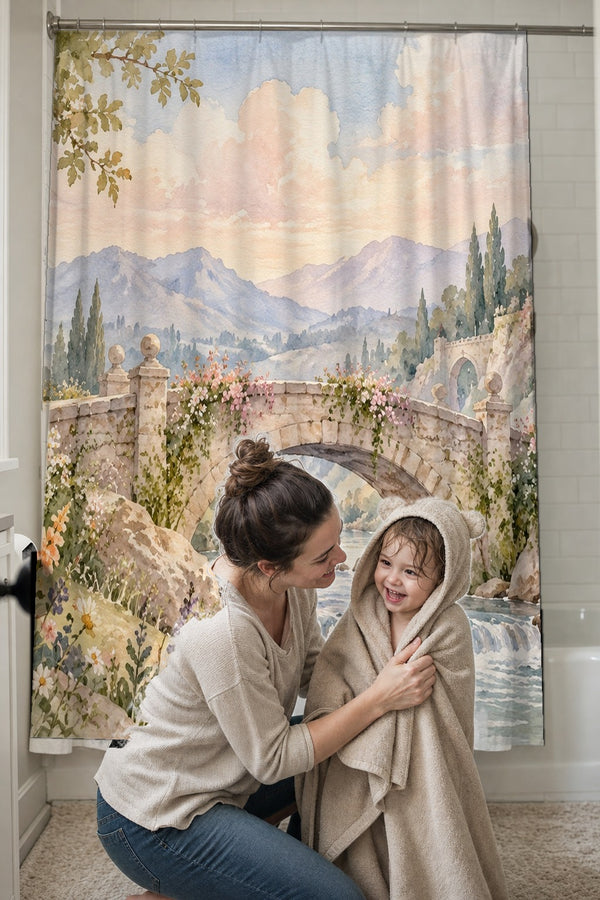 Mom drying her toddler in a hooded towel in front of the Castle Bridge Fairy Tale shower curtain