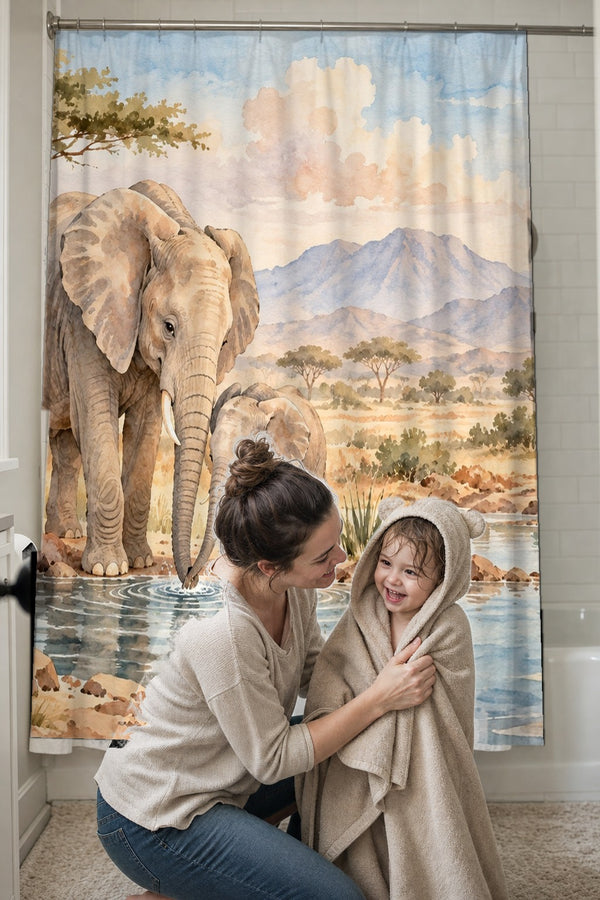 Mom drying her toddler in a hooded towel in front of the Elephant Family Safari shower curtain