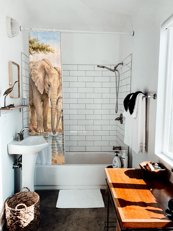 Elephant Family Safari shower curtain hanging on the rod over a white bathtub