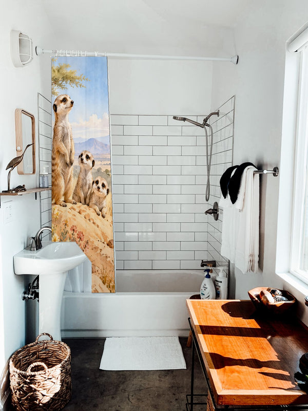 Meerkat Family Safari shower curtain hanging on the rod over a white bathtub