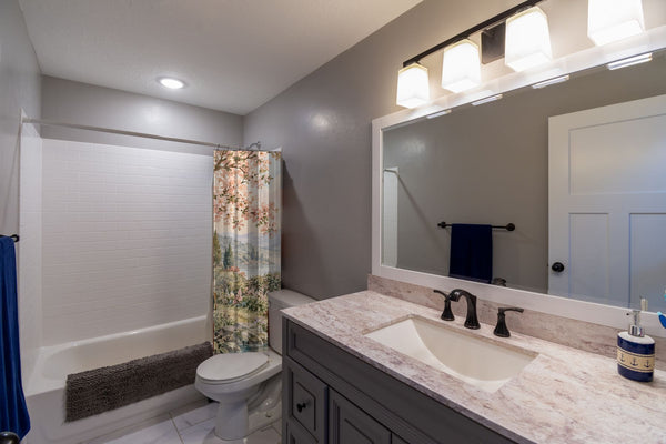 Woodland Castle Fairy Tale shower curtain pulled open in a gray kids bathroom