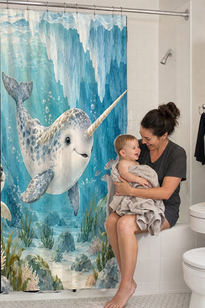 Mom holding her baby on the tub edge next to the Baby Narwhal Ocean shower curtain