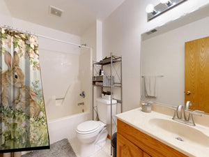 Apple Blossom Family Bunny shower curtain on a tub shower combo in an American family bathroom