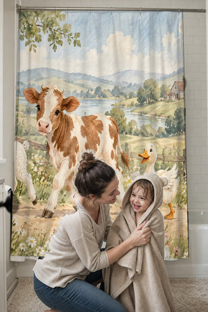 Mom drying her toddler in a hooded towel in front of the Farm Parade shower curtain