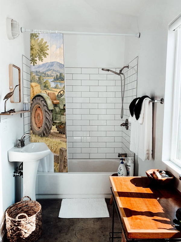 Farm Tractor shower curtain hanging on the rod over a white bathtub