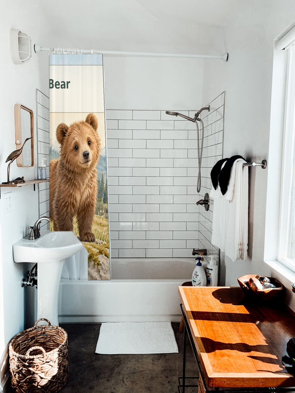 B is for Bear Alphabet shower curtain hanging on the rod over a white bathtub