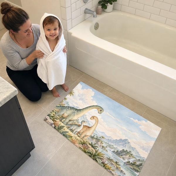 Mom and toddler in a hooded towel next to the Long Neck Family Dinosaur bath mat