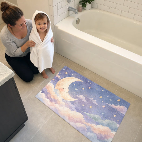 Mom and toddler in a hooded towel next to the Sleepy Moon bath mat