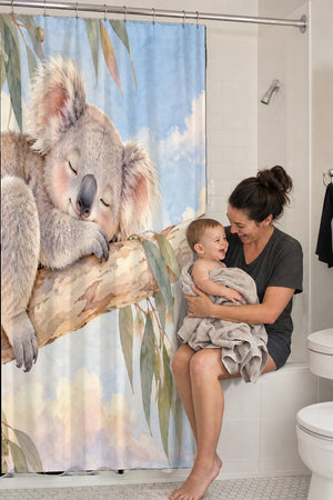 Mom holding her baby on the tub edge next to the Sleepy Koala shower curtain