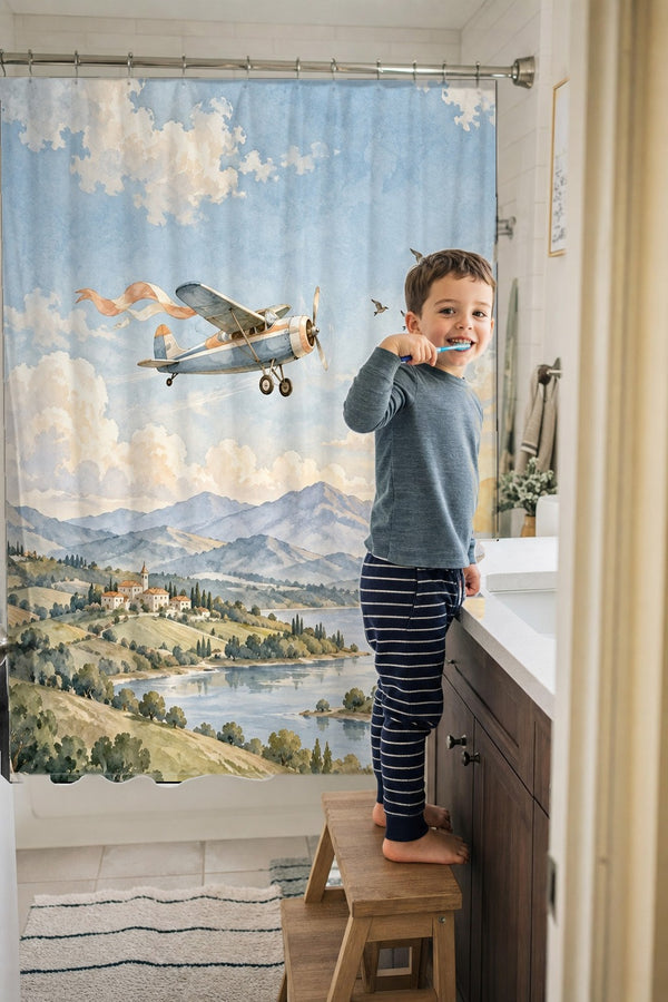 Child brushing teeth in a family bathroom with the Balloon and Plane shower curtain